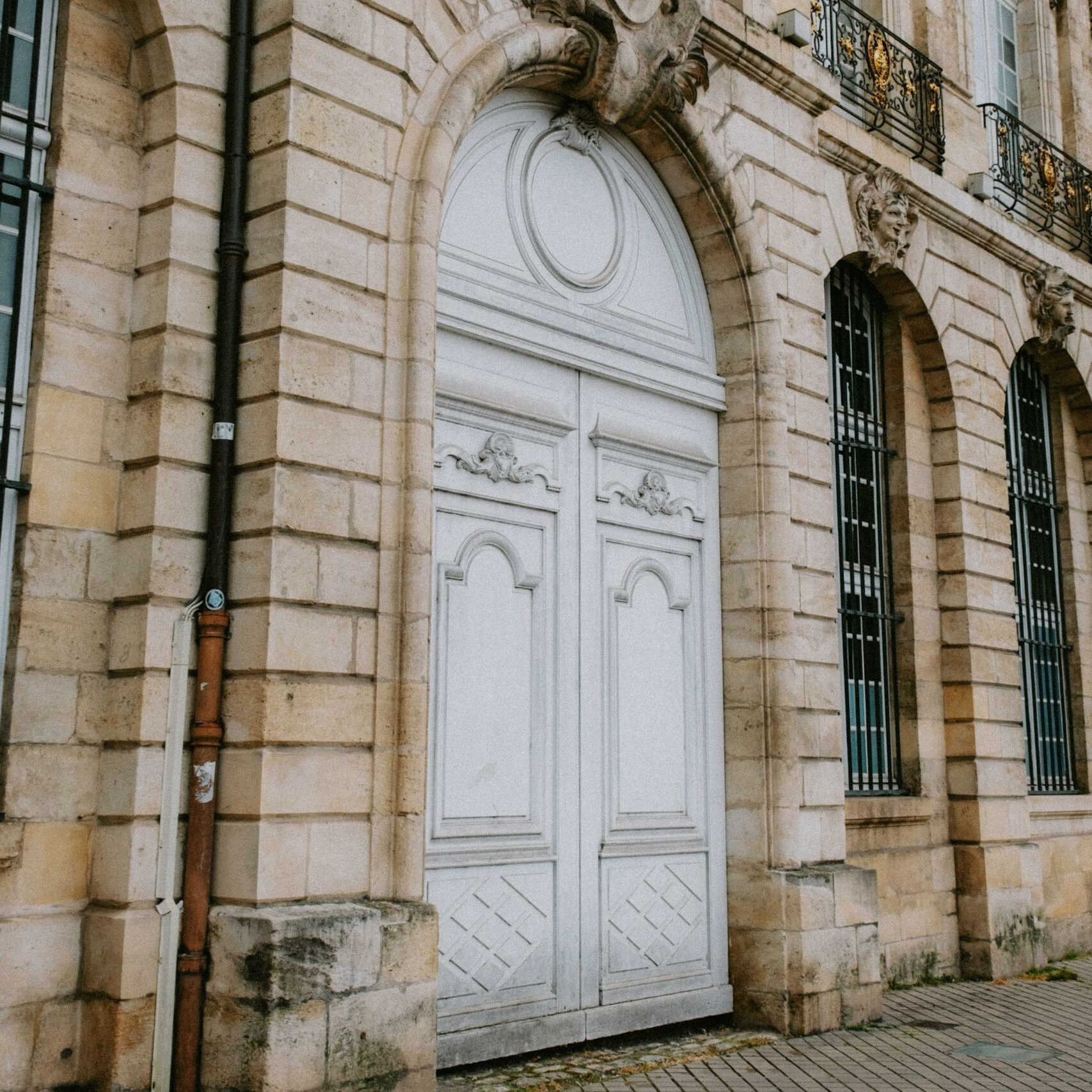 Capture of a historic building's facade featuring elegant arched entrance in Bordeaux.